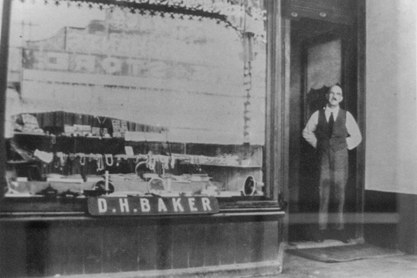 Founder Douglas Harry Baker standing in the doorway of his Geraldton store.